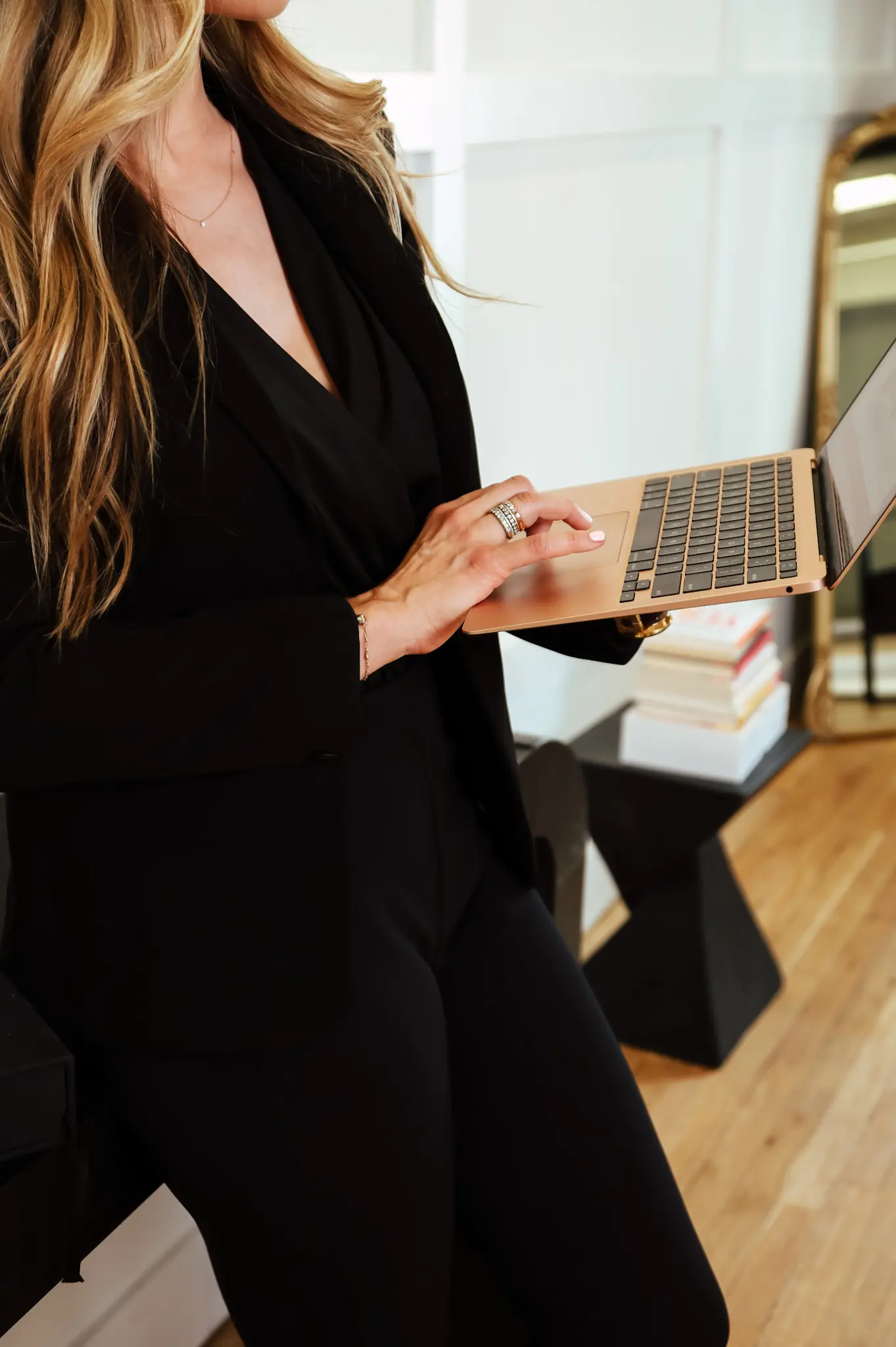 A woman holding an open laptop computer.